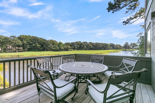 wooden terrace featuring a water view