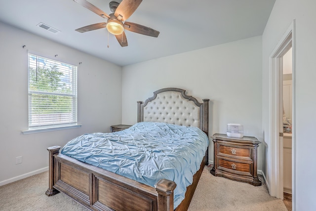 bedroom with light colored carpet, baseboards, and ceiling fan