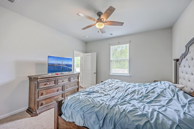 bedroom with carpet flooring, baseboards, and a ceiling fan