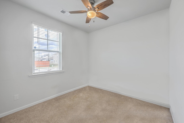 spare room with carpet, baseboards, and ceiling fan