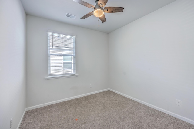 spare room with baseboards, a ceiling fan, and carpet flooring