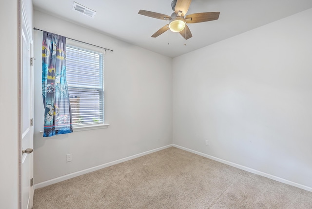 carpeted empty room featuring healthy amount of natural light, baseboards, and a ceiling fan
