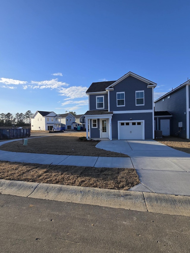 view of front facade featuring a residential view, concrete driveway, and an attached garage