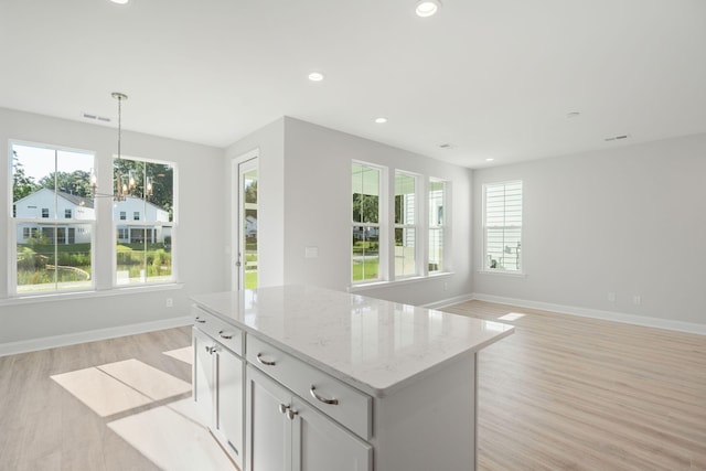 kitchen with recessed lighting, decorative light fixtures, and light wood-style flooring