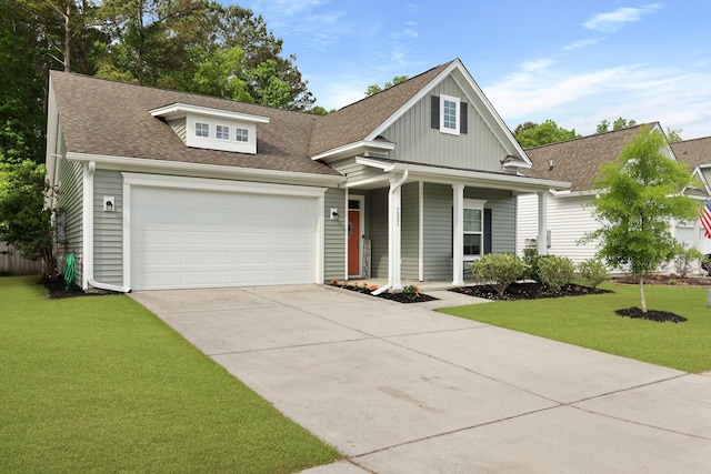view of front of home featuring covered porch, driveway, a front yard, and board and batten siding