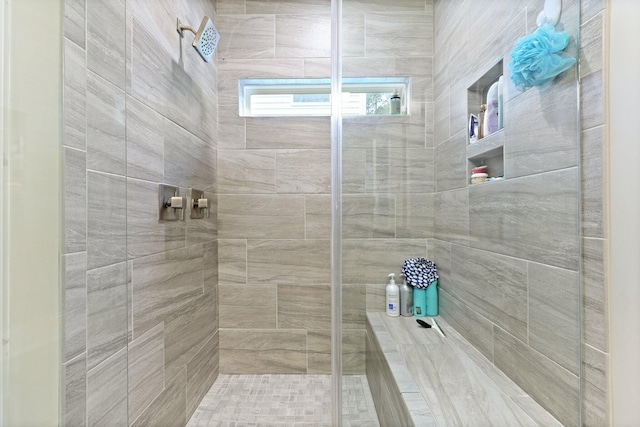bathroom with tiled shower
