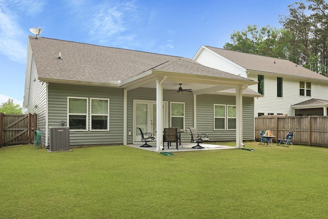 rear view of property featuring ceiling fan, a patio area, central AC unit, roof with shingles, and a gate