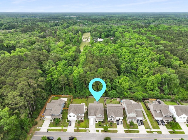 aerial view of residential area with a heavily wooded area