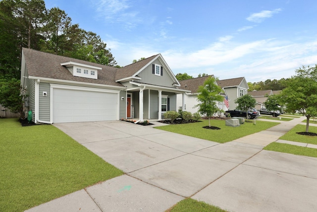view of front facade with concrete driveway, a front yard, roof with shingles, and a garage