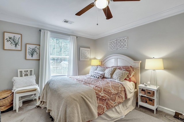 carpeted bedroom featuring ceiling fan and crown molding