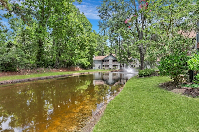 view of yard featuring a water view and central air condition unit