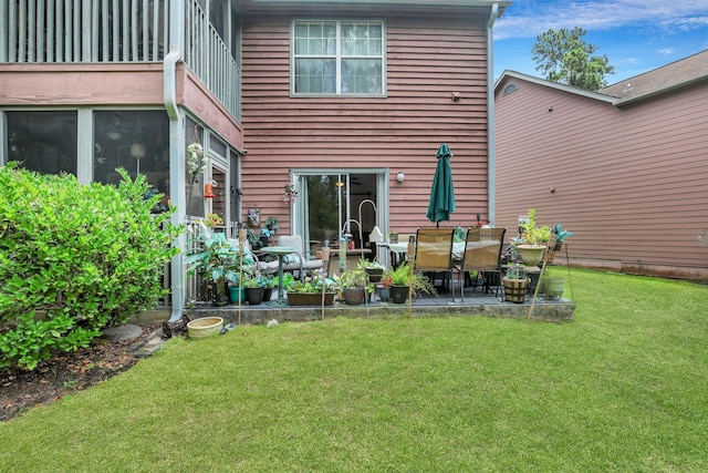 rear view of property with a patio area and a yard