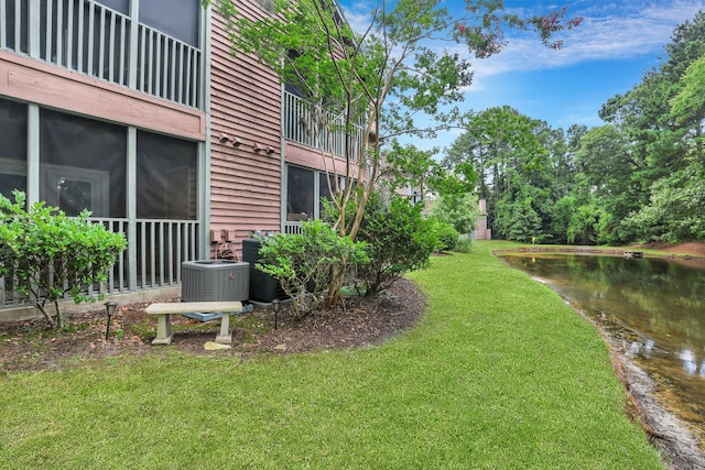 view of yard featuring a water view and central air condition unit