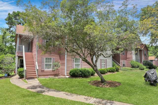 obstructed view of property with a front yard