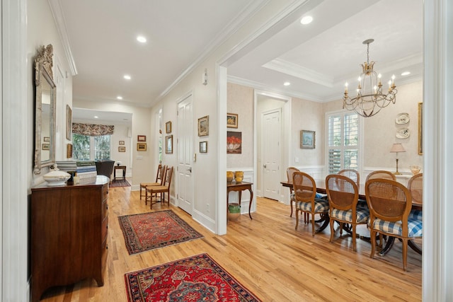 interior space featuring a healthy amount of sunlight, light wood-type flooring, and crown molding