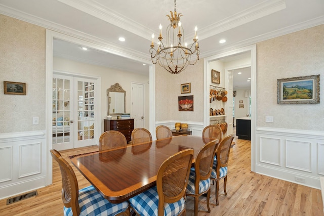 dining area with wallpapered walls, visible vents, a wainscoted wall, and french doors