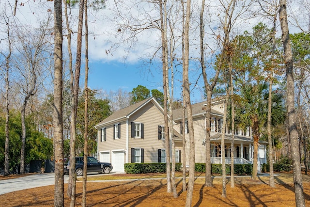 view of front of property with a garage, driveway, and covered porch