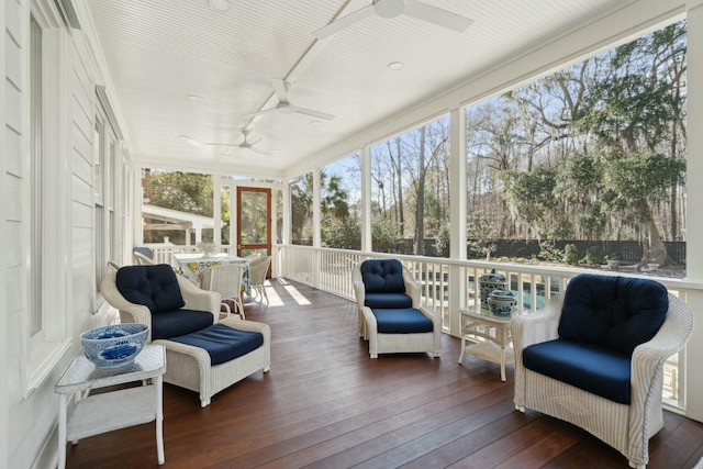 sunroom / solarium featuring ceiling fan