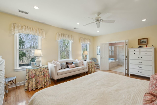 bedroom with recessed lighting, visible vents, light wood finished floors, and ensuite bathroom