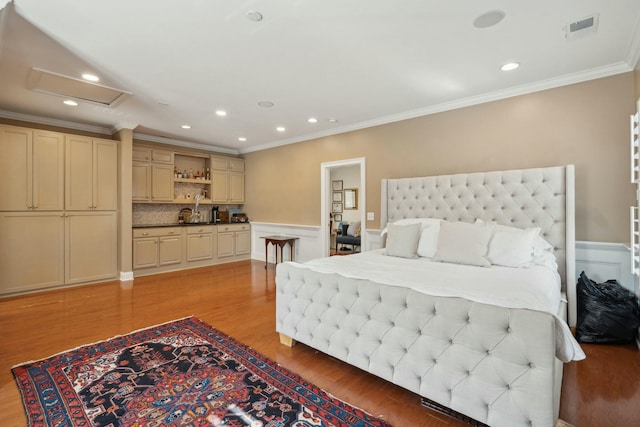 bedroom with crown molding, recessed lighting, visible vents, attic access, and light wood-type flooring