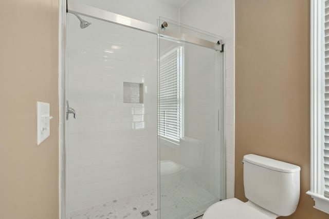 full bath with a shower stall and toilet