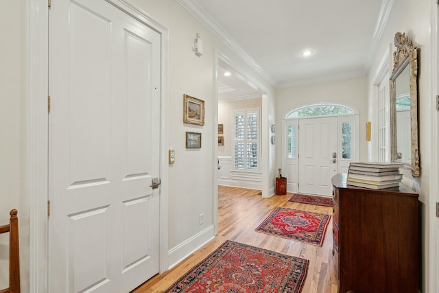 entrance foyer with baseboards, ornamental molding, recessed lighting, and light wood-style floors