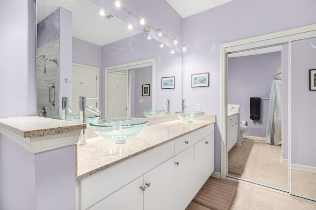 300 Bucksley Ln Unit 102, Charleston, SC 29492 - full bath featuring double vanity, tile patterned flooring, a shower, baseboards, and toilet