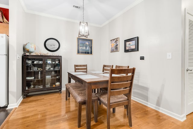 300 Bucksley Ln Unit 102, Charleston, SC 29492 - dining space with light wood-style floors, crown molding, baseboards, and a chandelier