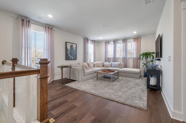 living area featuring baseboards, dark wood-style floors, and visible vents