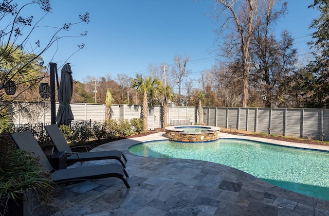 view of swimming pool with a patio area, a fenced backyard, and a pool with connected hot tub