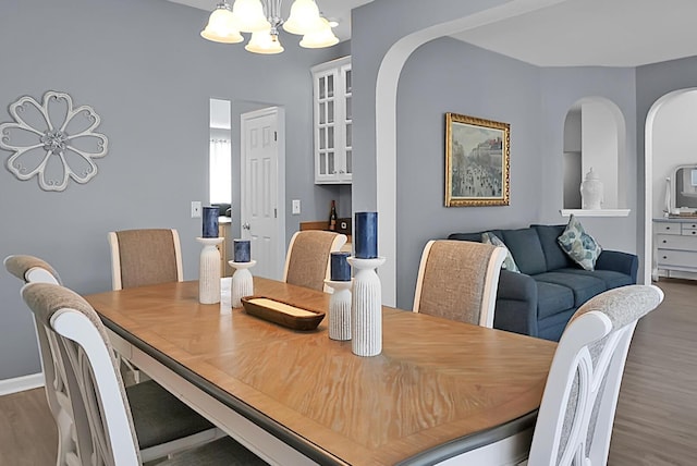 dining area featuring a chandelier and wood finished floors