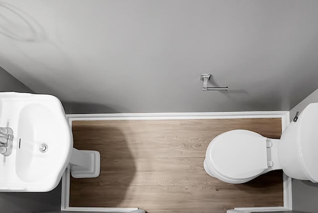 bathroom featuring toilet and wood finished floors