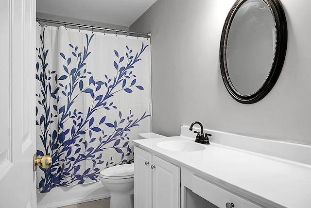 bathroom featuring vanity, toilet, and curtained shower