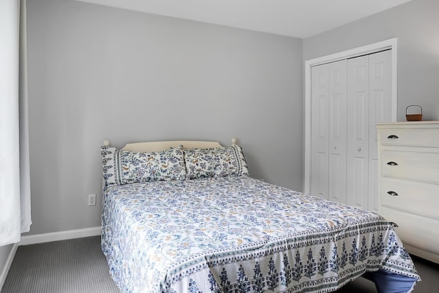 bedroom with carpet, a closet, and baseboards