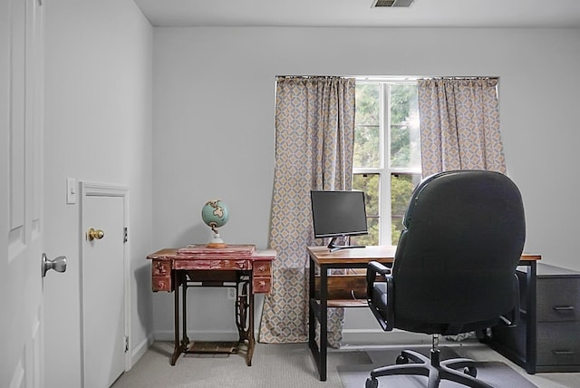 carpeted office space featuring baseboards