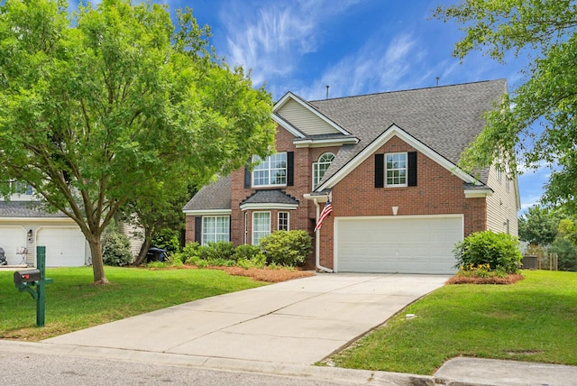 traditional-style house with driveway, brick siding, a front lawn, and roof with shingles