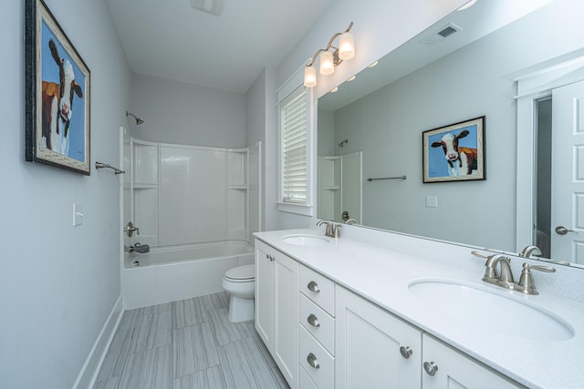 full bathroom with toilet, bathing tub / shower combination, double vanity, and baseboards