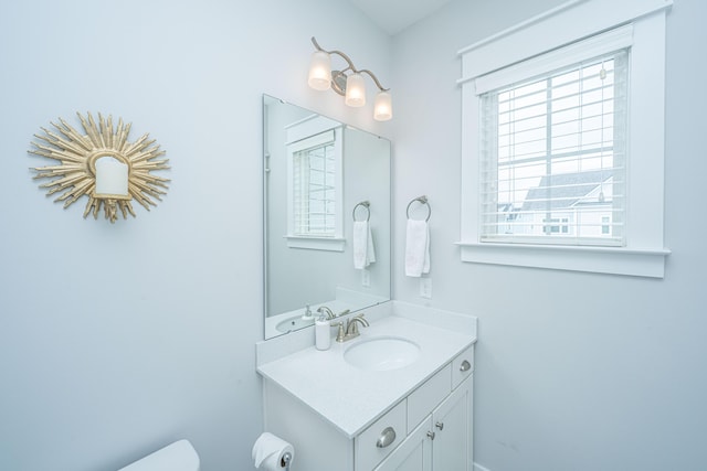 bathroom with toilet and vanity