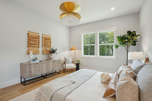 bedroom with recessed lighting, baseboards, and wood finished floors