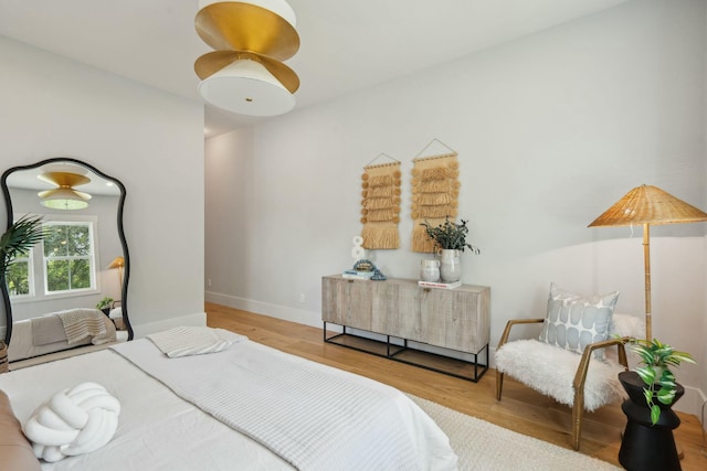 bedroom featuring baseboards and wood finished floors