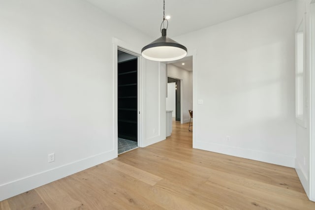 unfurnished dining area featuring light wood-type flooring