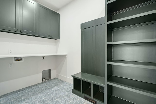 washroom featuring hookup for an electric dryer, washer hookup, and cabinets