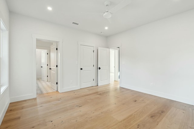 unfurnished bedroom featuring light wood-type flooring and ceiling fan