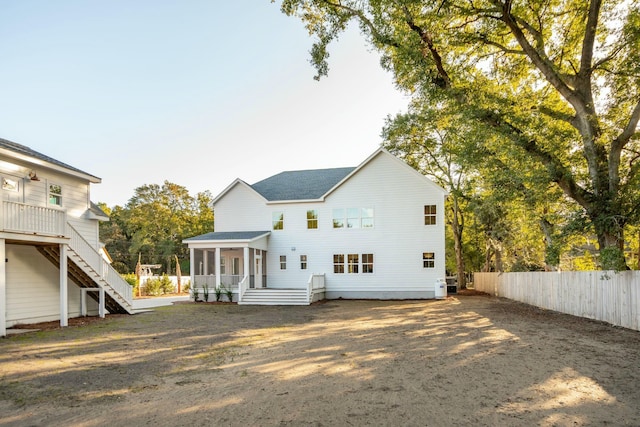 rear view of property featuring a deck