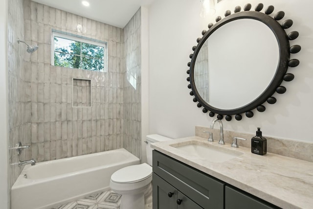 full bathroom featuring vanity, tiled shower / bath combo, and toilet