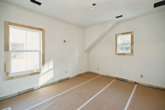 spare room with lofted ceiling