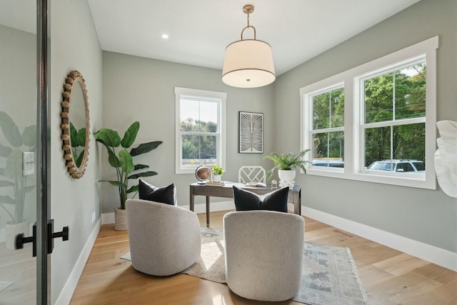 living area with baseboards, recessed lighting, and wood finished floors