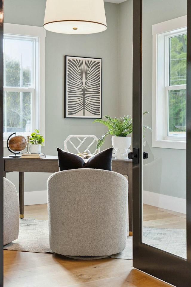 interior space featuring baseboards and wood finished floors