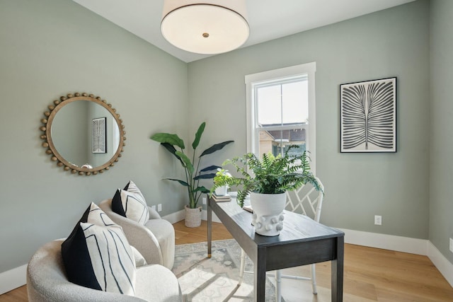 office area featuring baseboards and wood finished floors