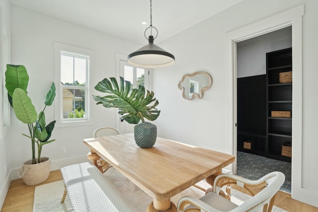 dining room featuring light wood-style floors and baseboards